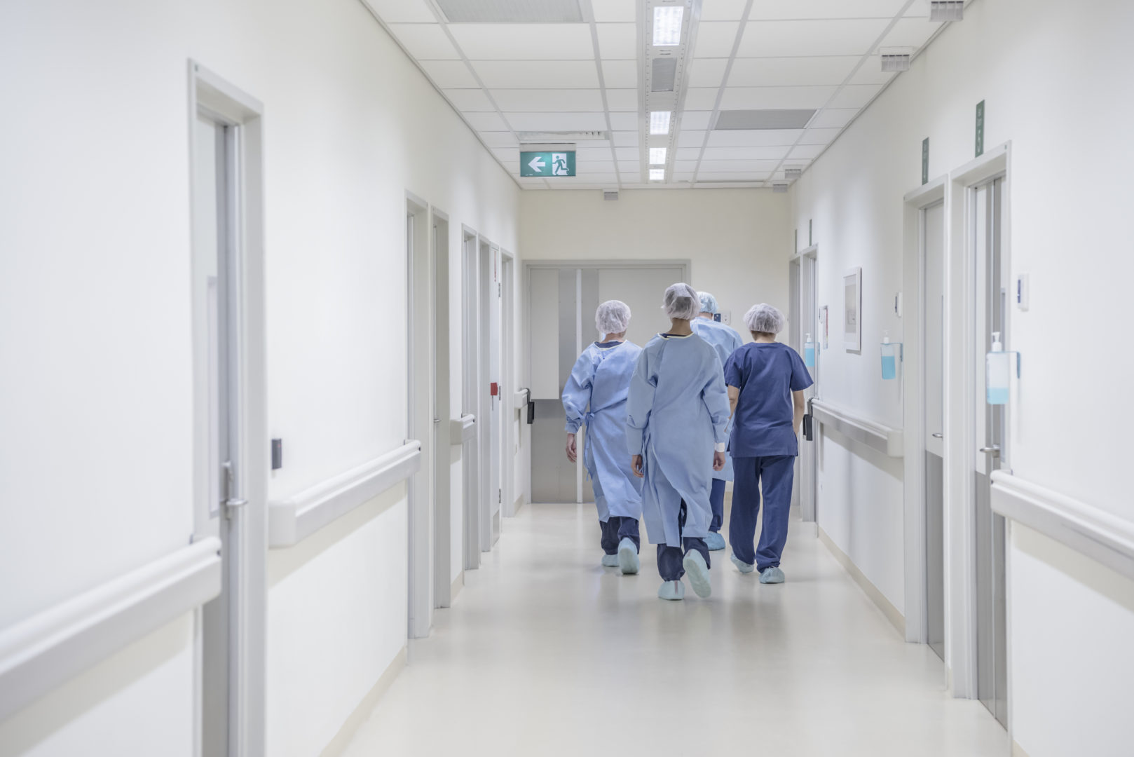 Doctors and nurses walking in scrubs in hospital