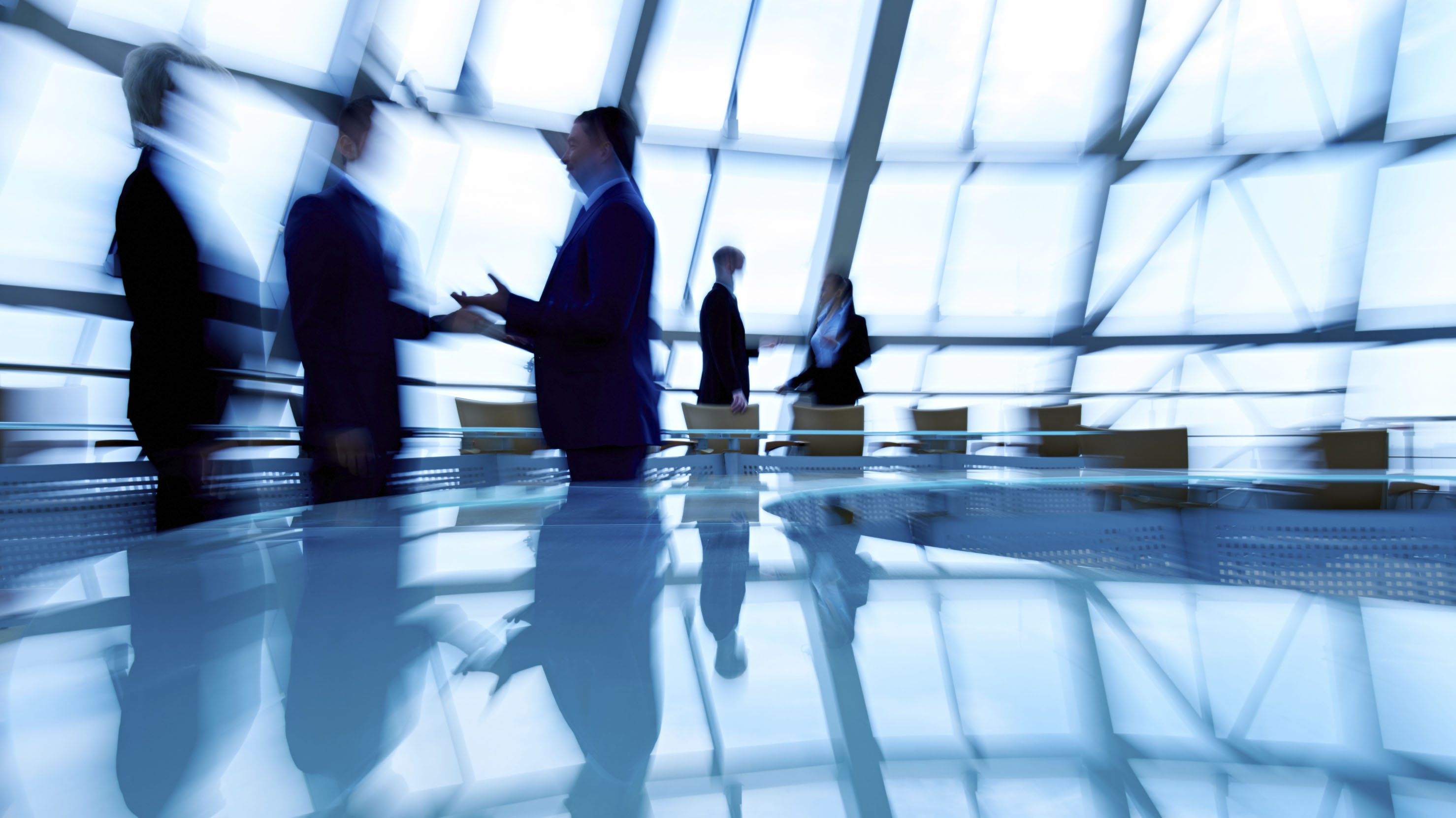Blurry image of business people standing and talking